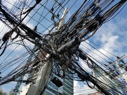 Wires pile up on the electrical poles easily found on any street of Thailand.