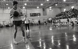 Legendary basketball player "Pistol" Pete Maravich and his father, Press Maravich, demonstrate for the large crowd of attendees at Campbell University's Basketball Camp in 1970.