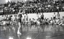 Basketball legend "Pistol" Pete Maravich shoots baskets in front of Campbell University Basketball Camp participants.