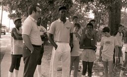 Considered the greatest basketball player of all time, Michael Jordan was a UNC basketball star and legend in the early 1980s. Pictured here waiting outside at Campbell's basketball camp with an unidentified male and campers.