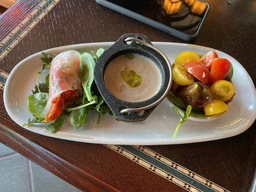 Mushroom soup, vegetable spring roll with chili sauce, and a tomato salad.