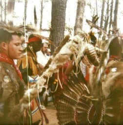 Men in traditional regalia preparing for tribal dance circa 1990