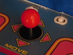 Joystick control on a classic Pac-Man arcade game machine.