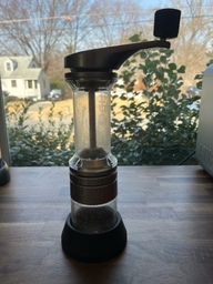 This is a manual grinder. Beans are placed in the top and are ground by twisting the handle. The ground beans are dispensed into the removable bottom jar.