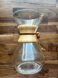 This is a Chemex, which is a type of pour over. A filter is placed in the top and the grounds are added to the filer. Hot water is poured over the grounds and the brewed coffee collects in the bottom. 