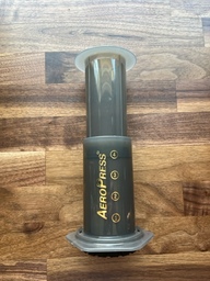 This is an Aeropress, and it's a useful, compact way to brew coffee. Coffee grounds and hot water are added to the container and the stopper with a filter is screwed on top. After the coffee has steeped, the container is flipped over and the plunger is depressed to push the coffee through the filter.