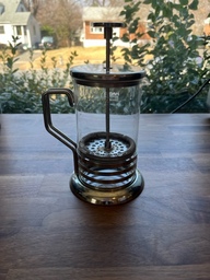 This is a french press. The filter is pulled to the top and coffee grounds and hot water are added to the bottom. Once the grounds have steeped, the plunger is depressed to filter the grounds from the brewed coffee.