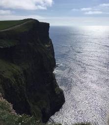 An angle of the Cliffs of Moher and the fenced walkway