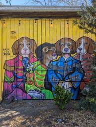 The Charleston Pour House is a live music venue located at 1977 Maybank Highway in James Island, SC. This mural by Kelly Kopacka is on the side of their building and depicts four dogs dressed like the Beatles on Sgt Pepper's Lonely Hearts Club-- with brightly colored and flamboyant jackets resembling military dress uniforms. The words say hairofthedogportraits.com by Kelly Kopacka.