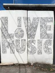 The Charleston Pour House is a live music venue located at 1977 Maybank Highway in James Island, SC. This mural says "live music" in black and grey with intricate line drawings inside each block letter. 