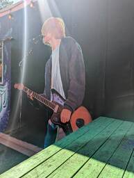 The Charleston Pour House is a live music venue located at 1977 Maybank Highway in James Island, SC. This mural, by @ameliacounts_art, is a realistic painting of Kurt Cobain standing while playing the guitar and singing into a microphone. 