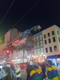 A crowd at the corner of Canal Street and Royal Street eagerly awaiting the arrival of the Krew of Endymion during Mardi Gras 2022.