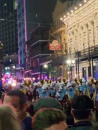 A local high school marching band marches down Canal Street as a part of the Krew of Endymion during Mardi Gras 2022.