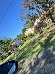 Educational political campaign sign in front of house. 