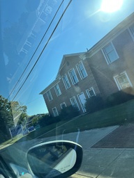 In front of a Law Office building are three different kinds of political campaign signs. 